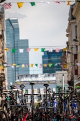 A group of bikes parked in a vibrant urban setting.