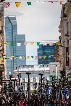 A group of bikes parked in a vibrant urban setting.