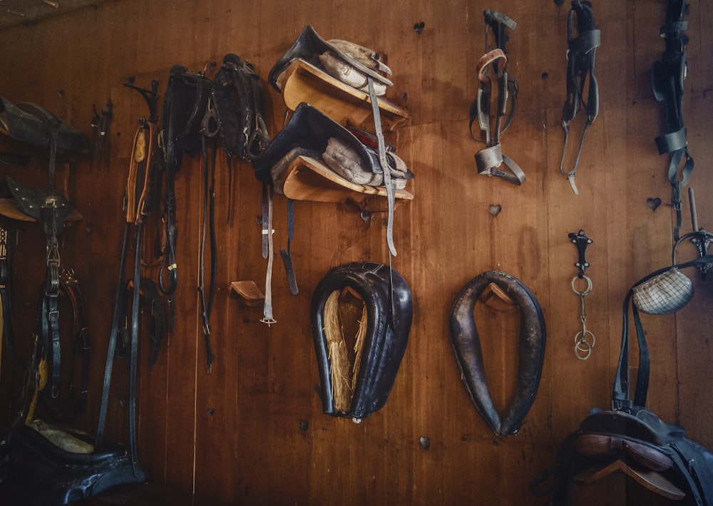 brown leather saddles on brown wall