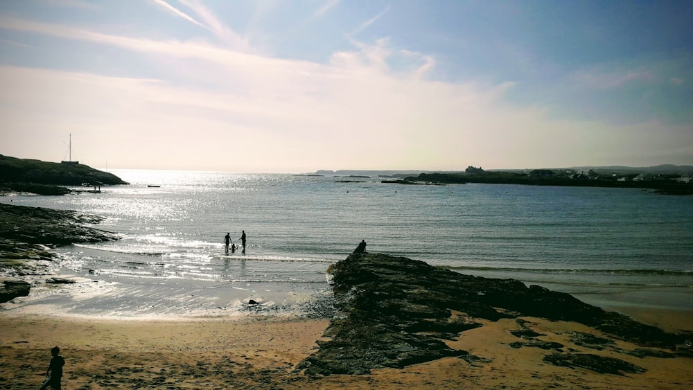 two people standing on shore