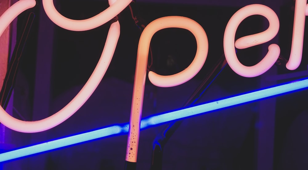 a close up of a neon sign on a building