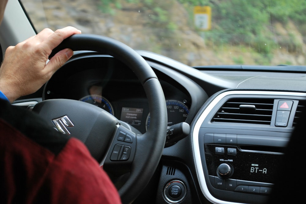 person sitting inside Suzuki vehicle