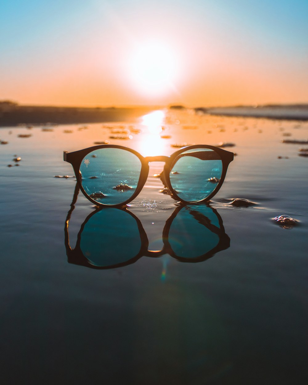 black framed teal lens sunglasses during daytime