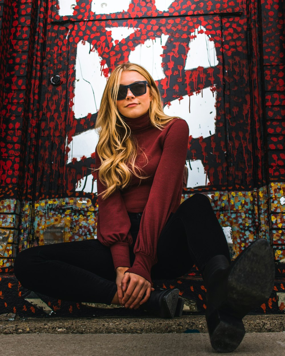 woman wearing red long-sleeved shirt and black sunglasses