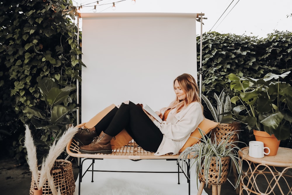 woman in white top sitting on sofa