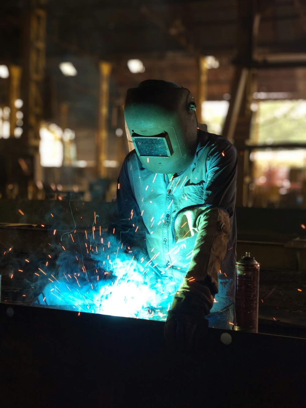 man welding inside building