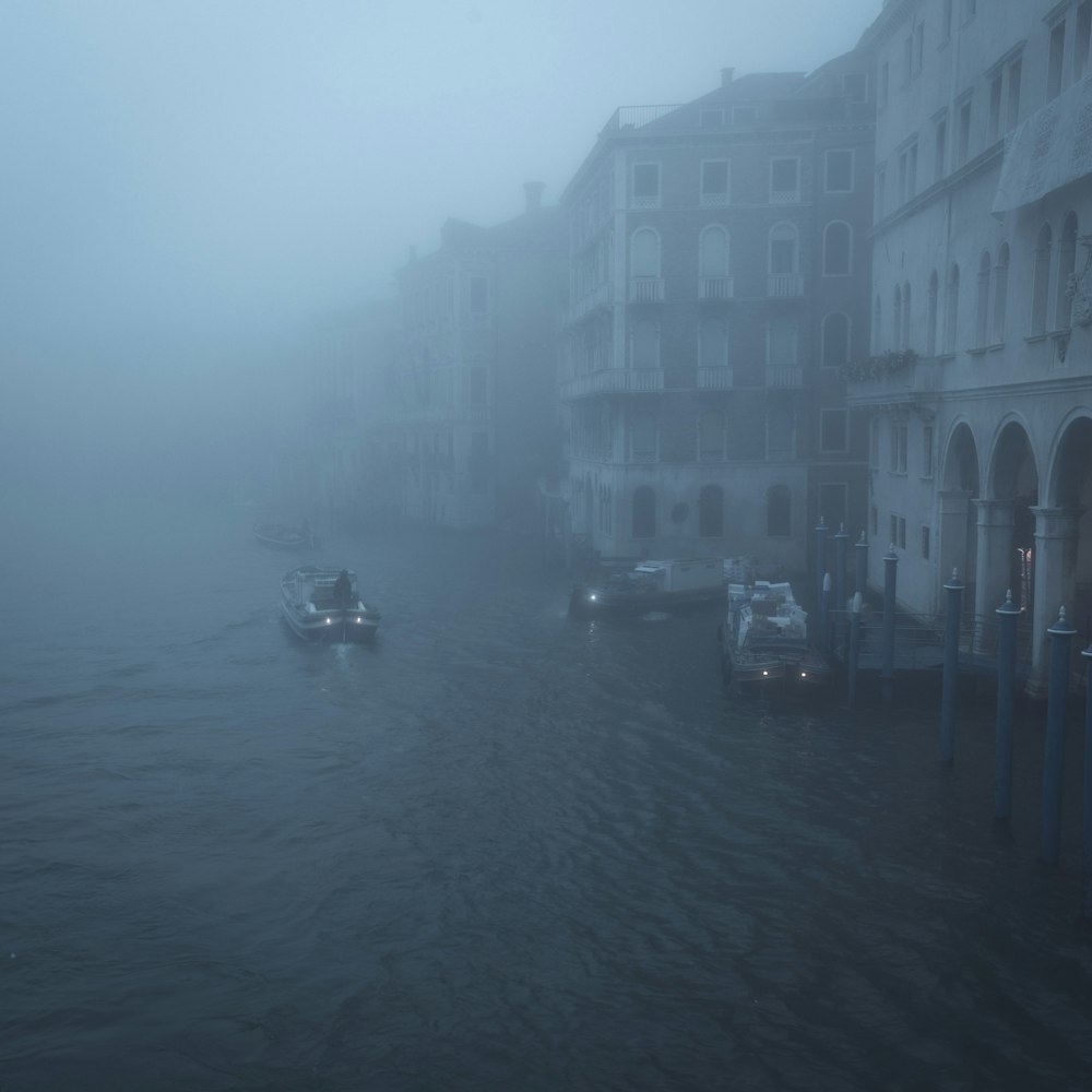 a boat traveling down a river on a foggy day