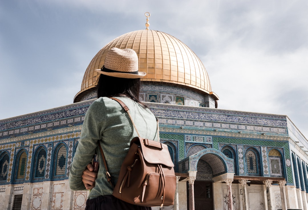 person wearing brown leather backpack