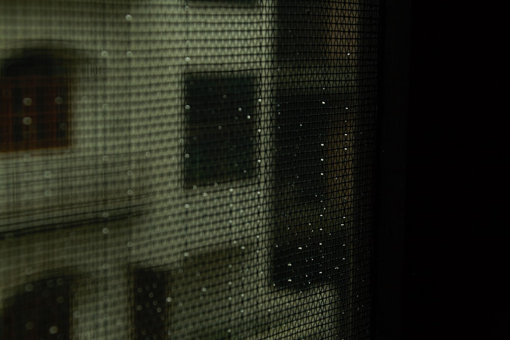 a close up of a window with a building in the background