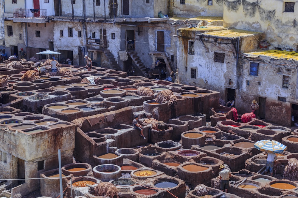 a large group of clay pots in front of a building