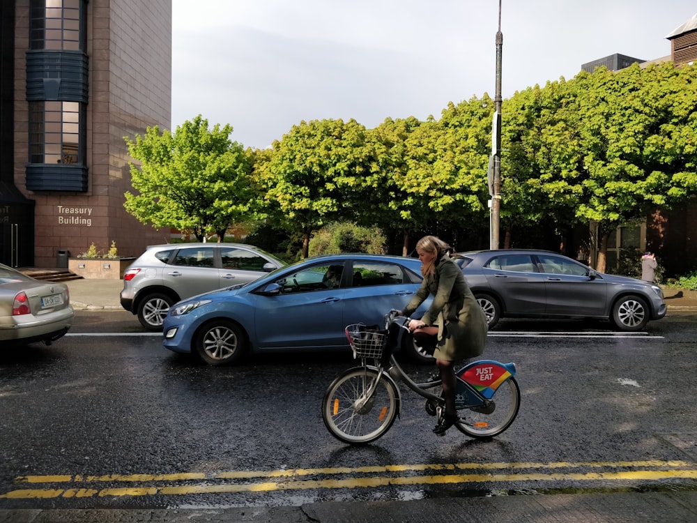 woman wearing coat riding on bike
