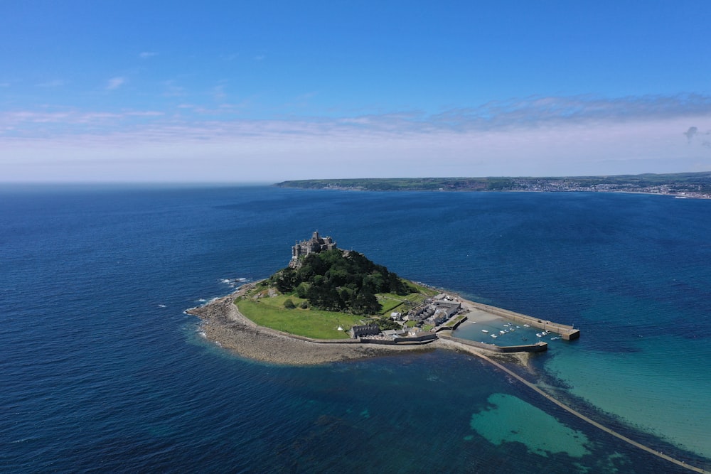 green islet during clear blue sky