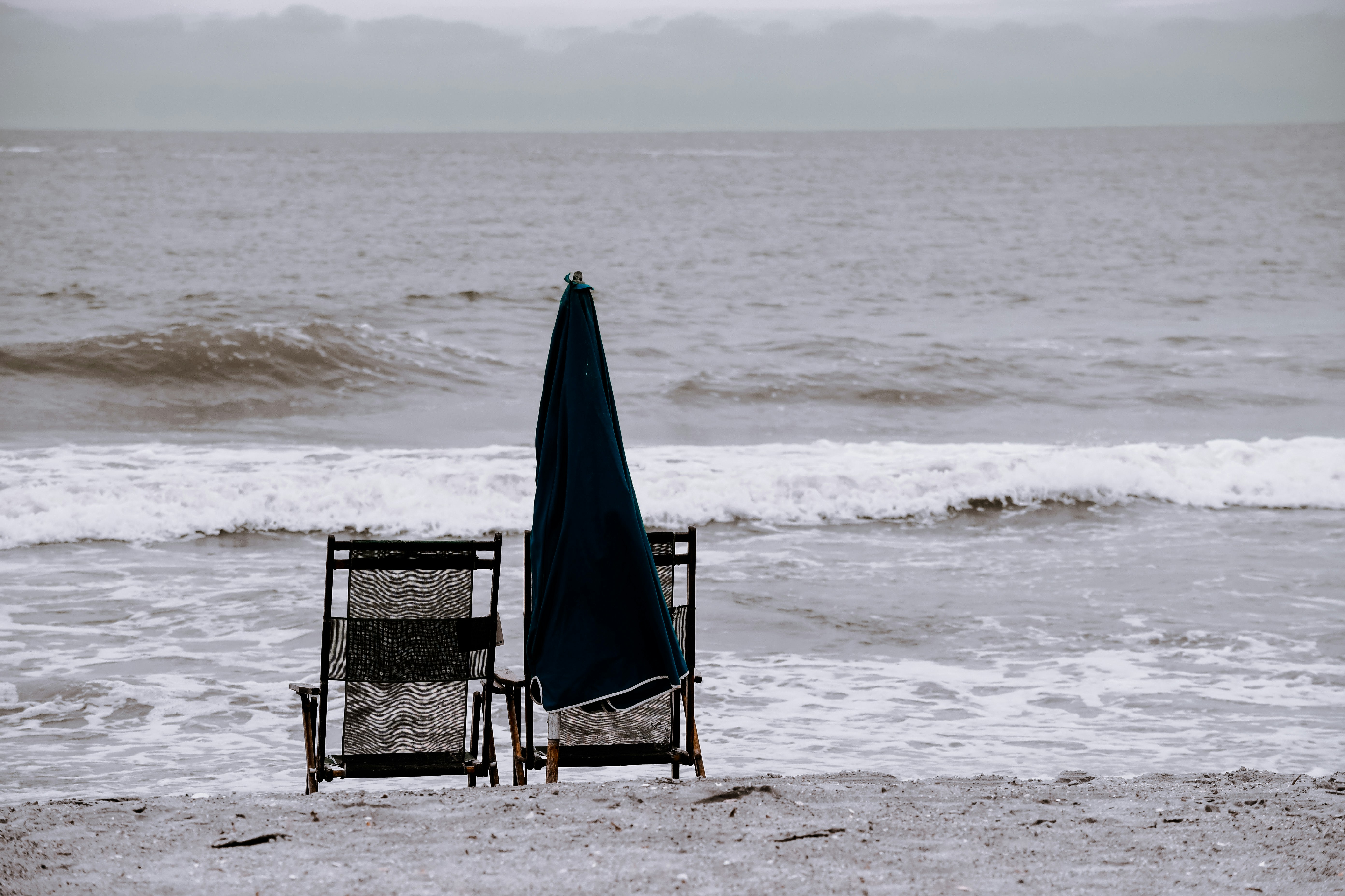 two black loungers on beac