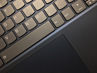 Close-up view of a laptop keyboard highlighting several keys, including Ctrl, Alt, and arrow keys, along with a portion of the touchpad.