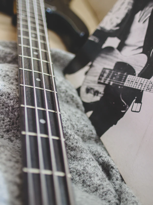 Close-up of hands playing an electric bass guitar