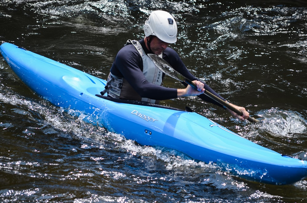 man riding on kayak