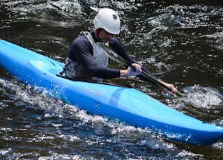 man riding on kayak