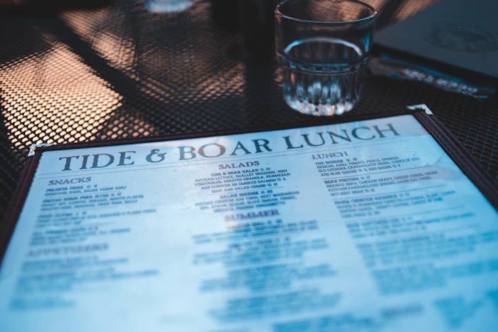 Printed restaurant menu listing dishes by section, representing digital menu search