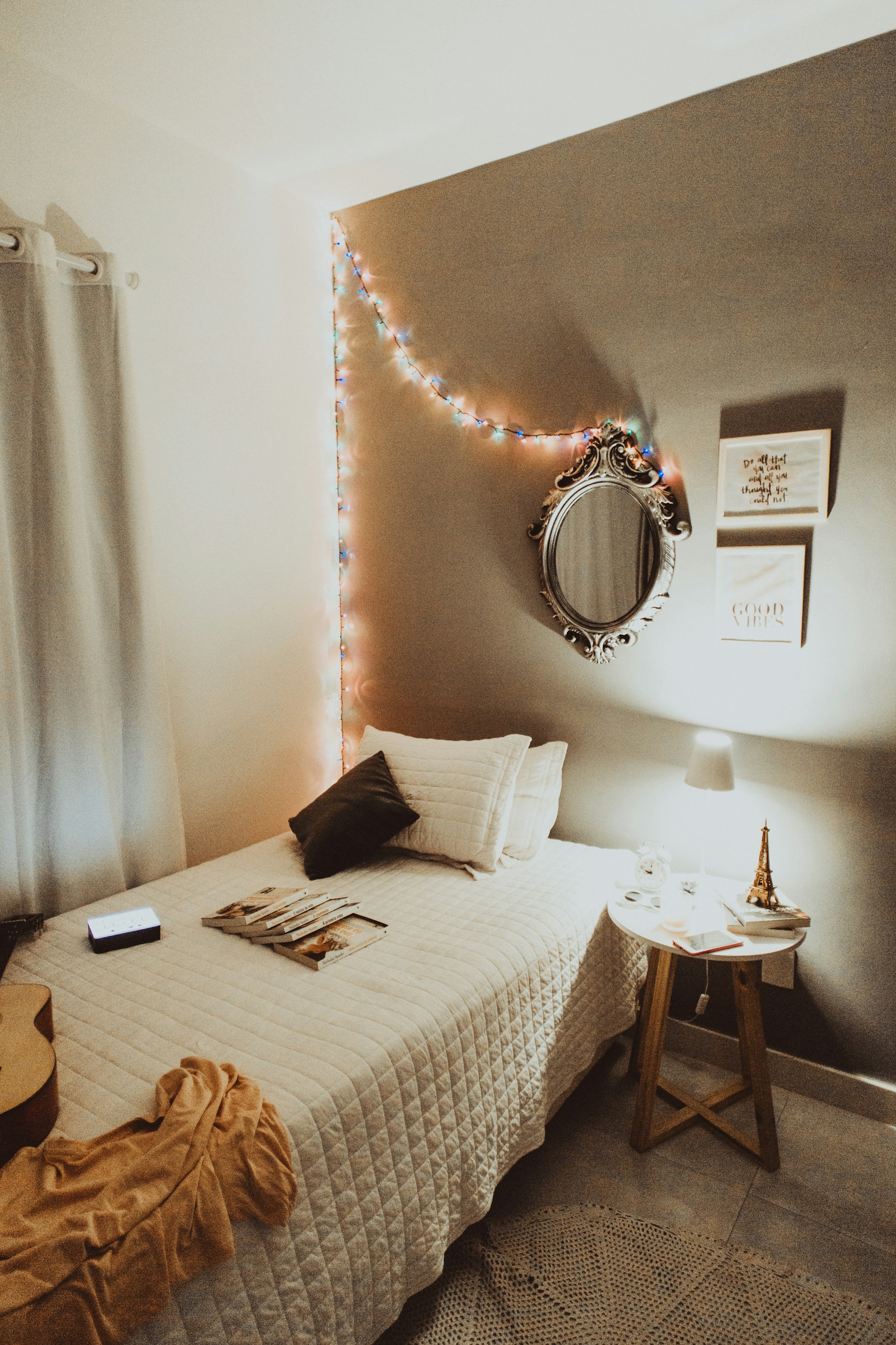 single bed with books and guitar