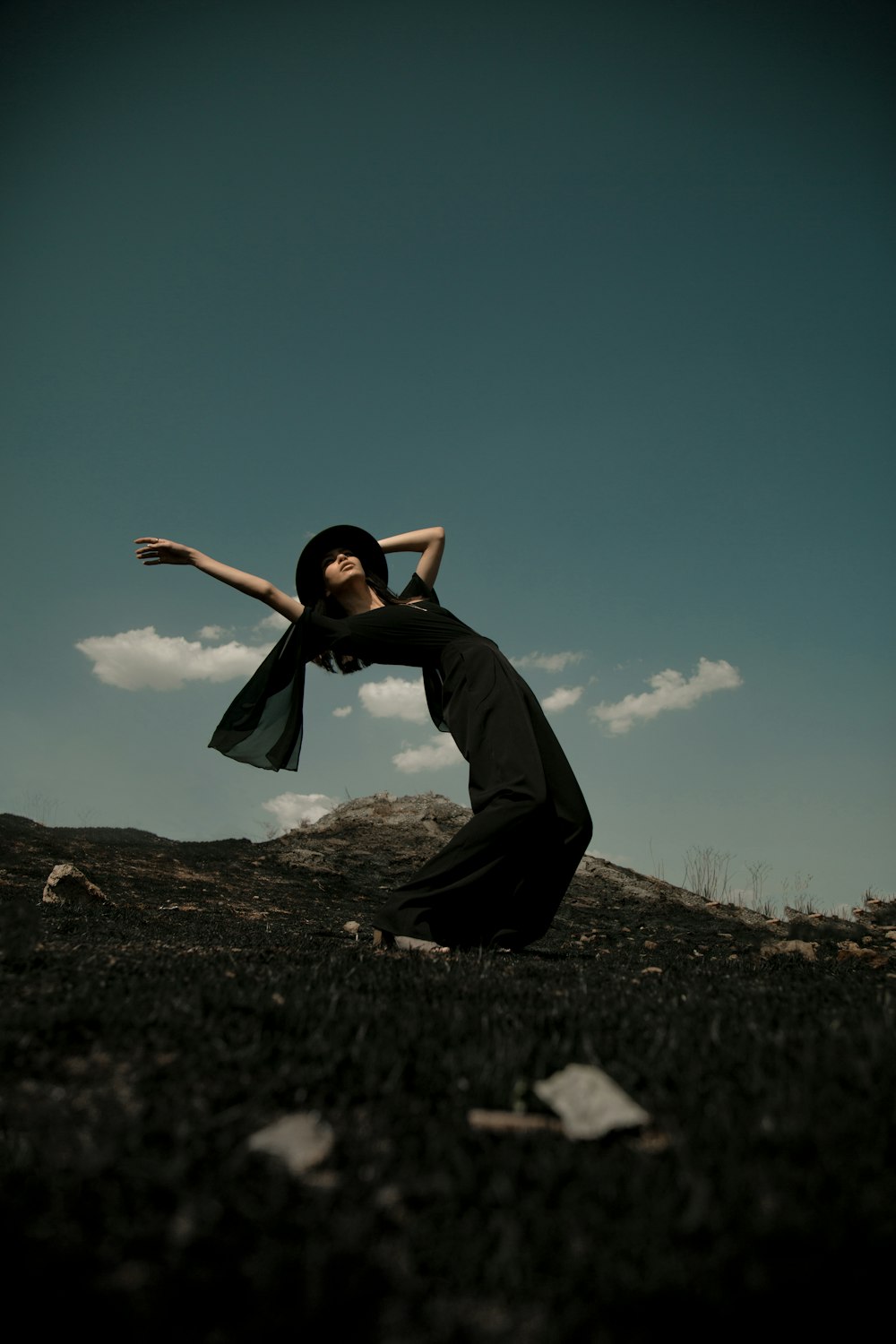 woman in black dress bending