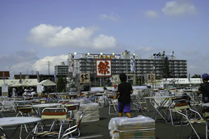 Organizers coordinating logistics on tablets in a busy outdoor festival setting