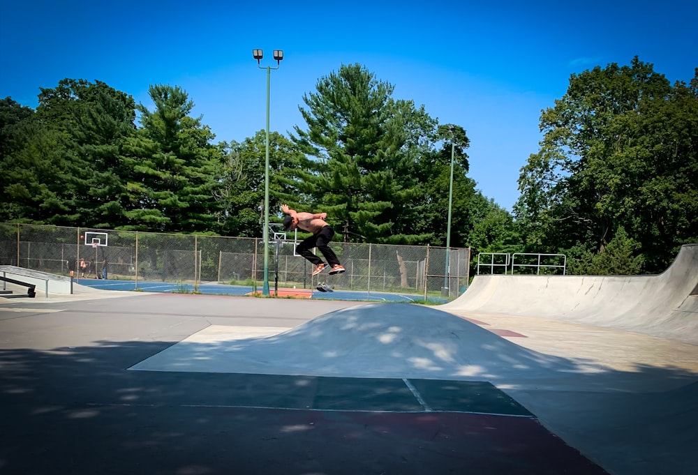 man skateboarding near trees