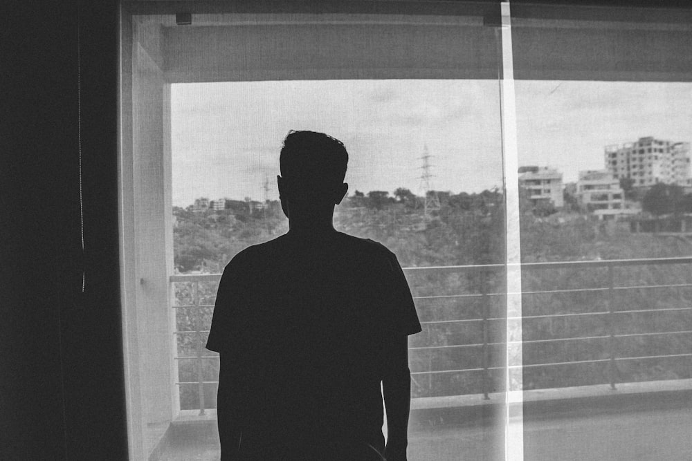 silhouette of man standing inside room