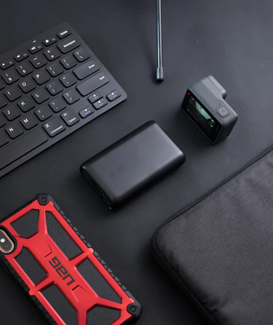 Flat lay of Maxtorc gear with mobile phone displaying the Vigora online store interface.