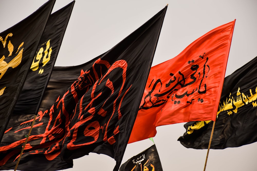 four black and one orange flags