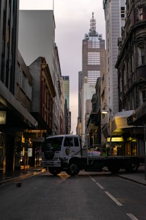 FAOB Transportes truck navigating through an urban road with city buildings in the background.