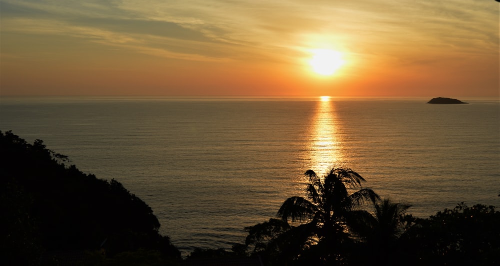 sunset over body of water