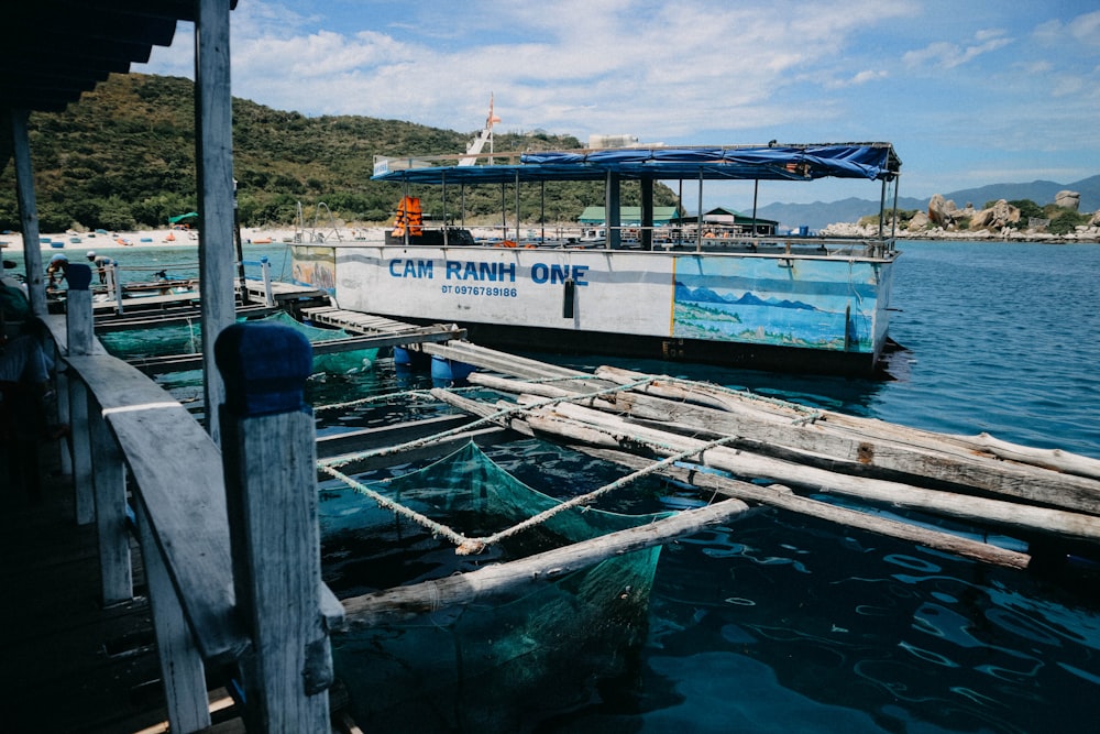 white and blue boat in body of water during daytime