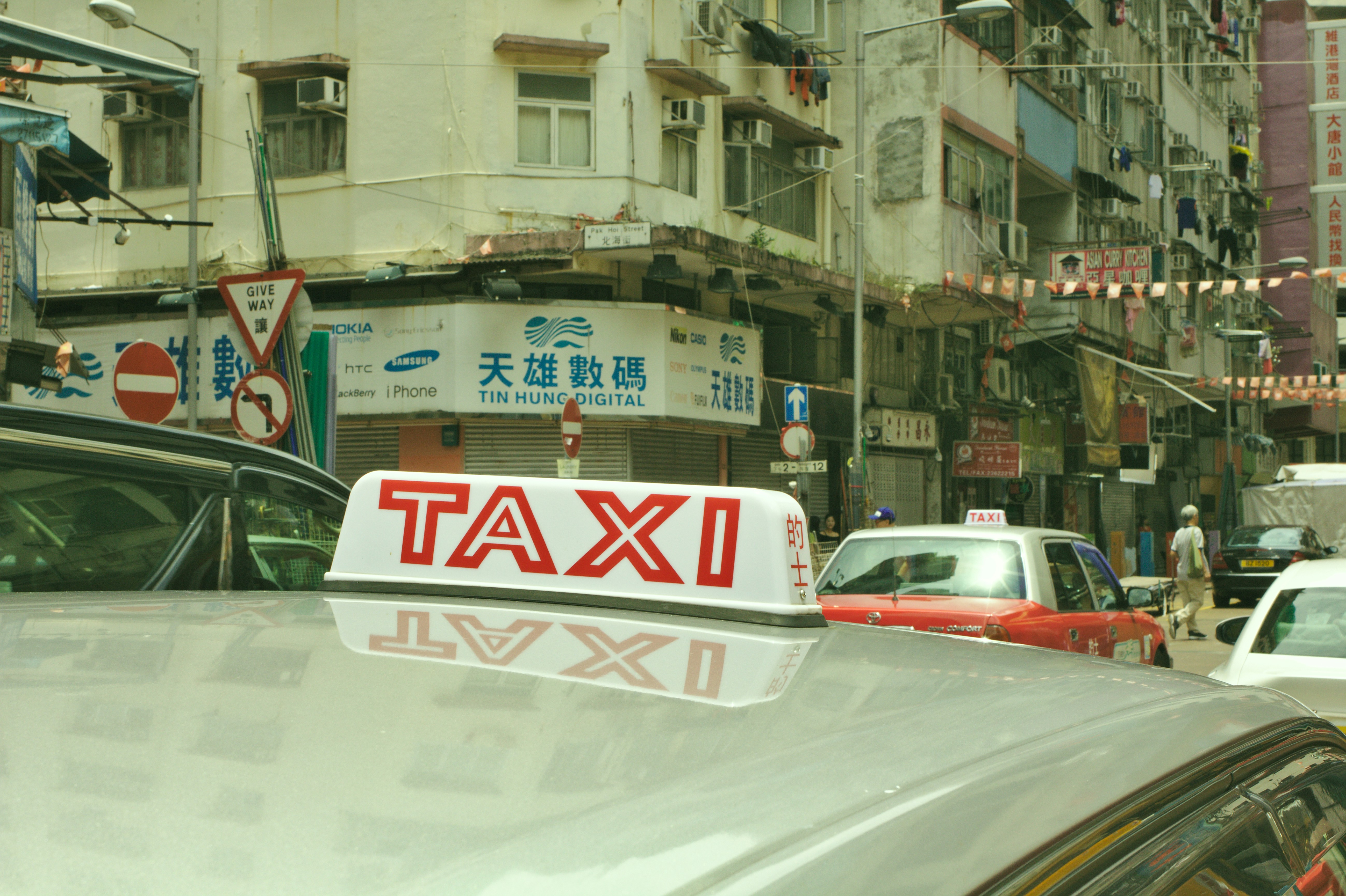 vehicles beside concrete buildings