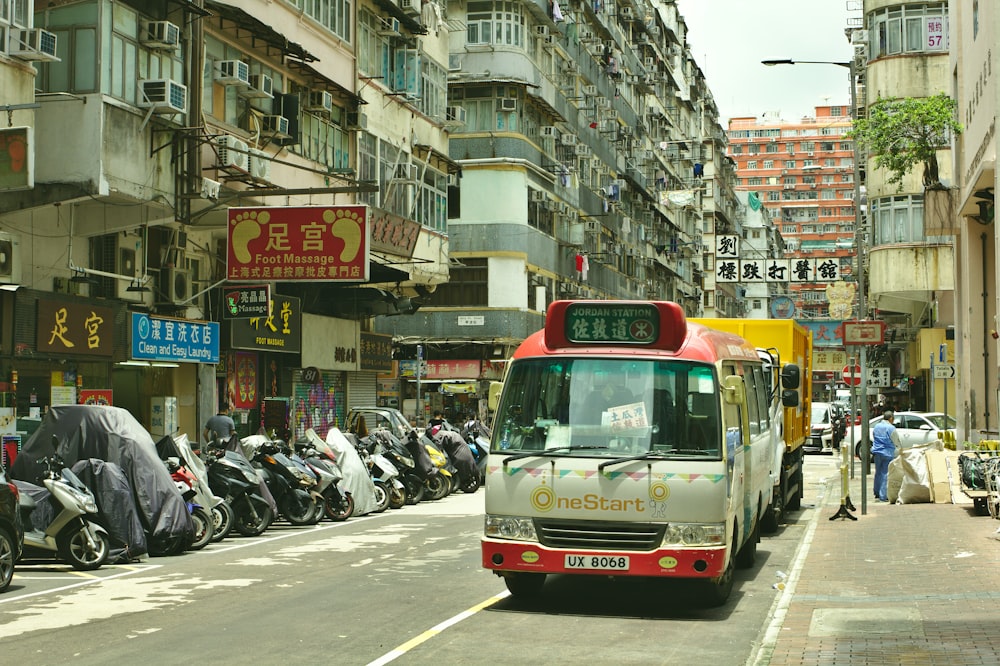 grey and red bus on street during daytime