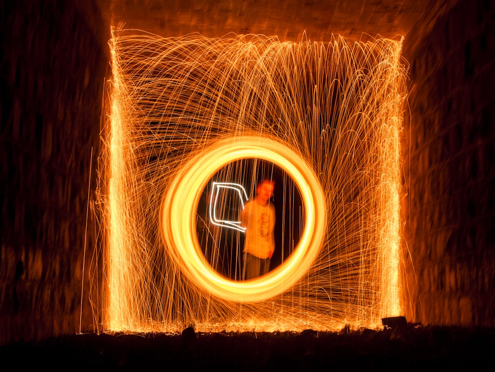 steel wool photography of man in white top