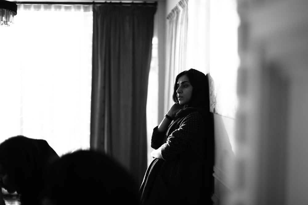 woman leaning on wall