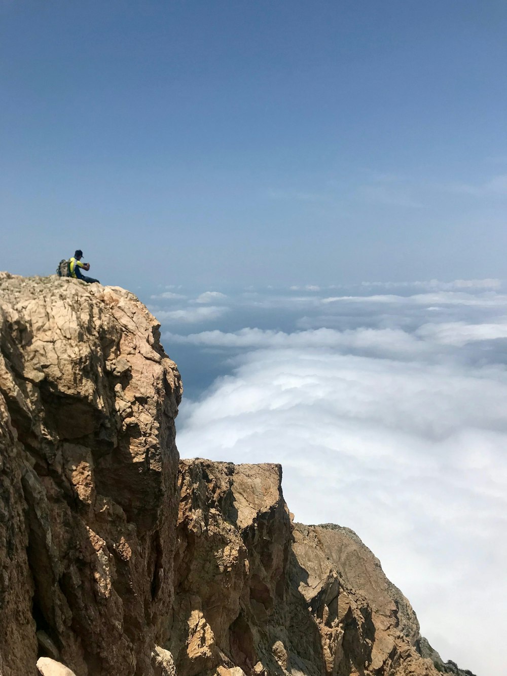 man sitting on cliff