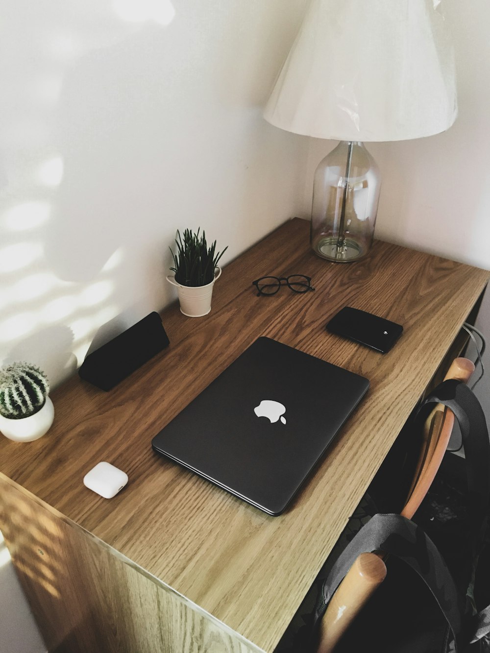 a wooden desk topped with a laptop computer