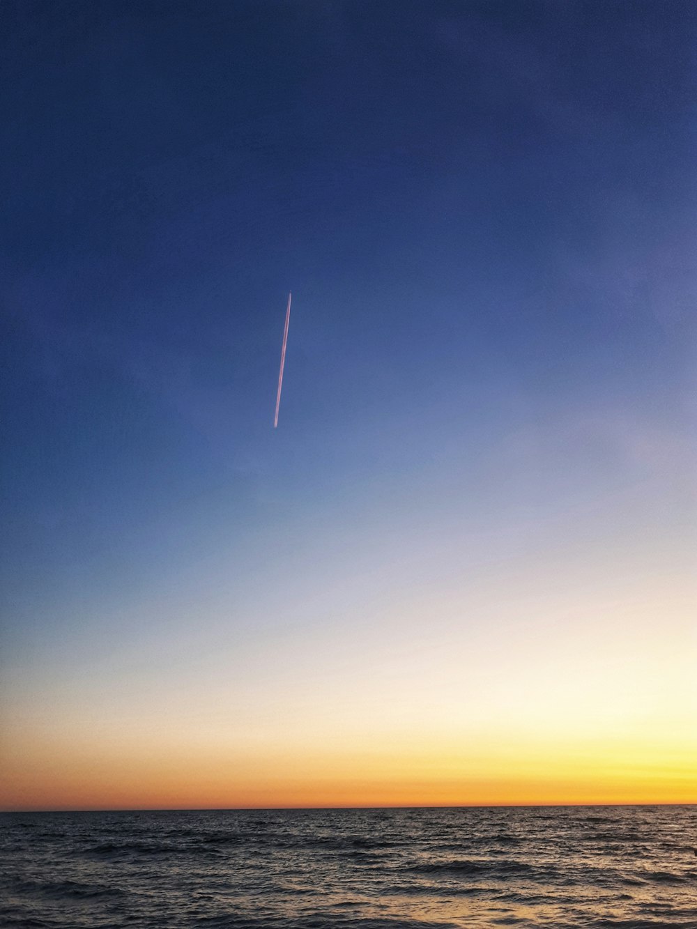 body of water under blue sky