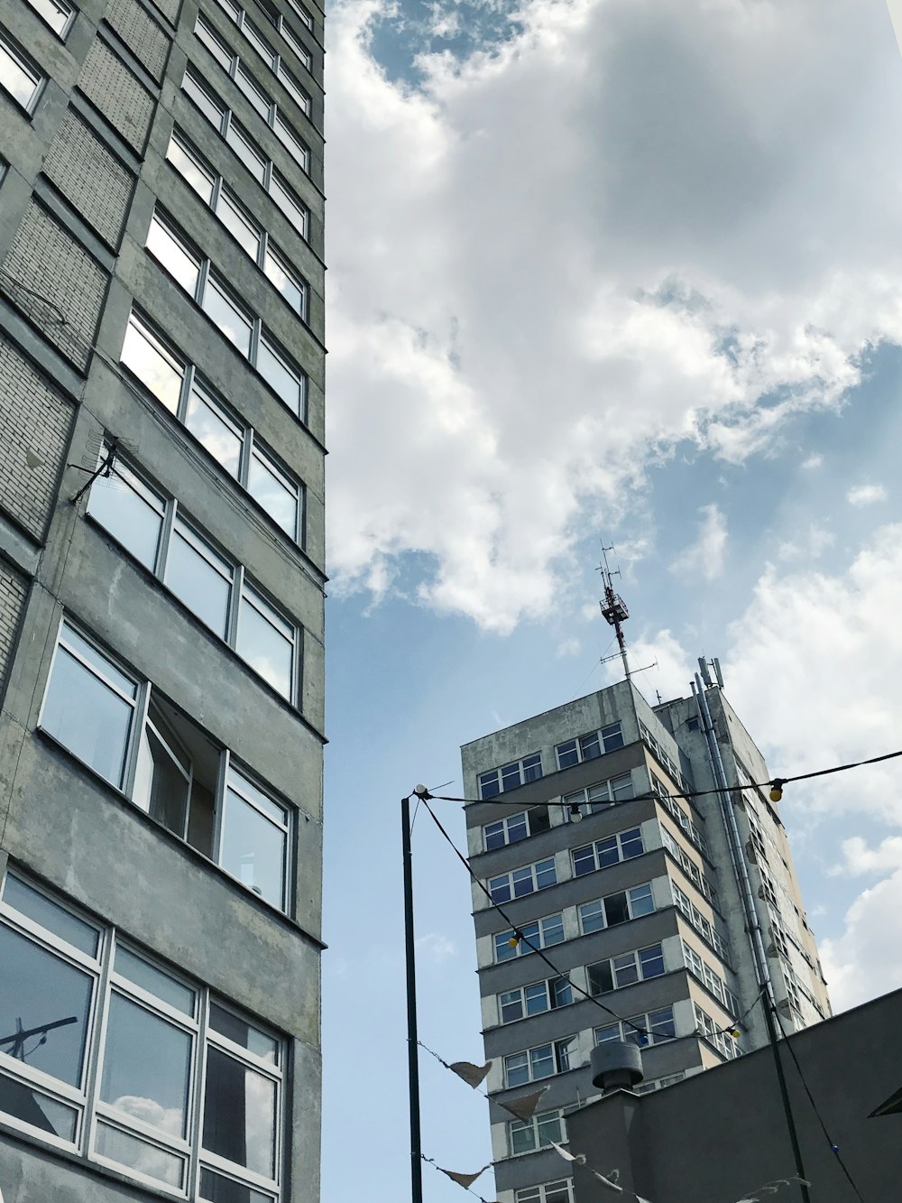 low-angle photography of high-rise buildings under cloudy sky