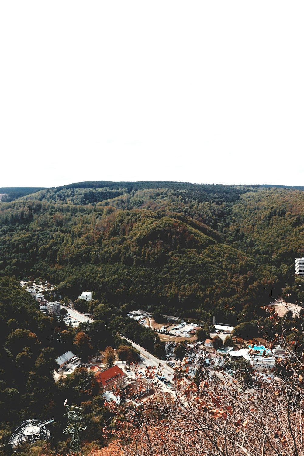 a scenic view of a town surrounded by trees