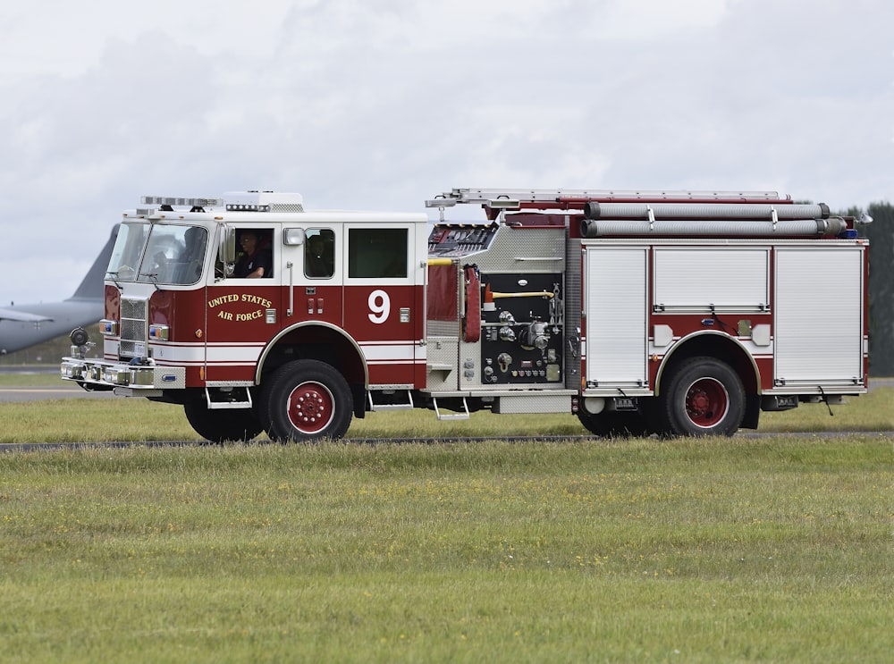 white and red vehicle on green grass