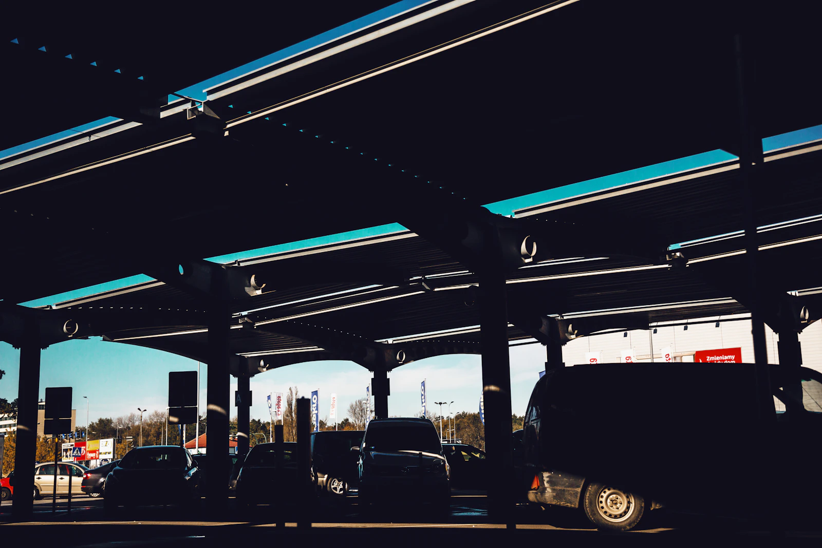 Vehicles queue beneath the roof of a Polish motorway service facility