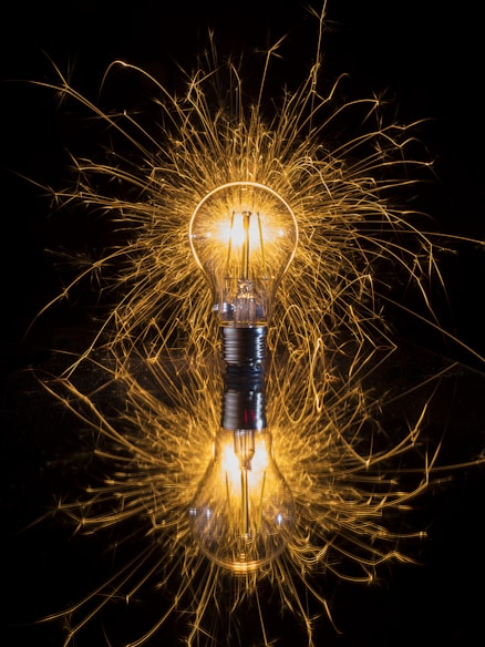 light bulb reacting with sparks  indicating transformation