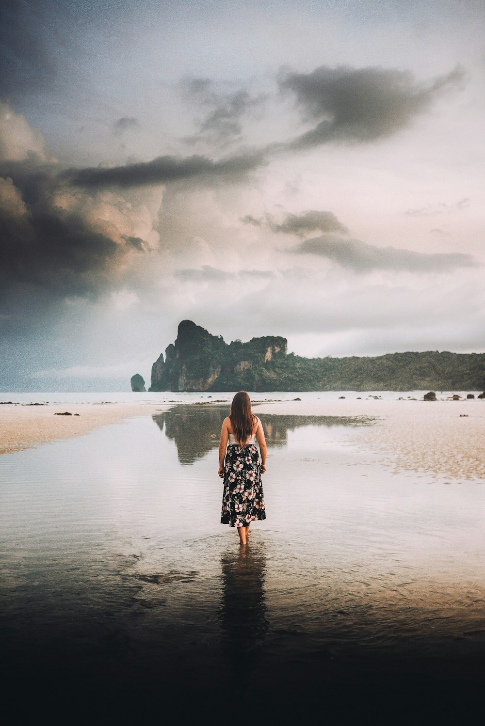 woman in black dress walking on water