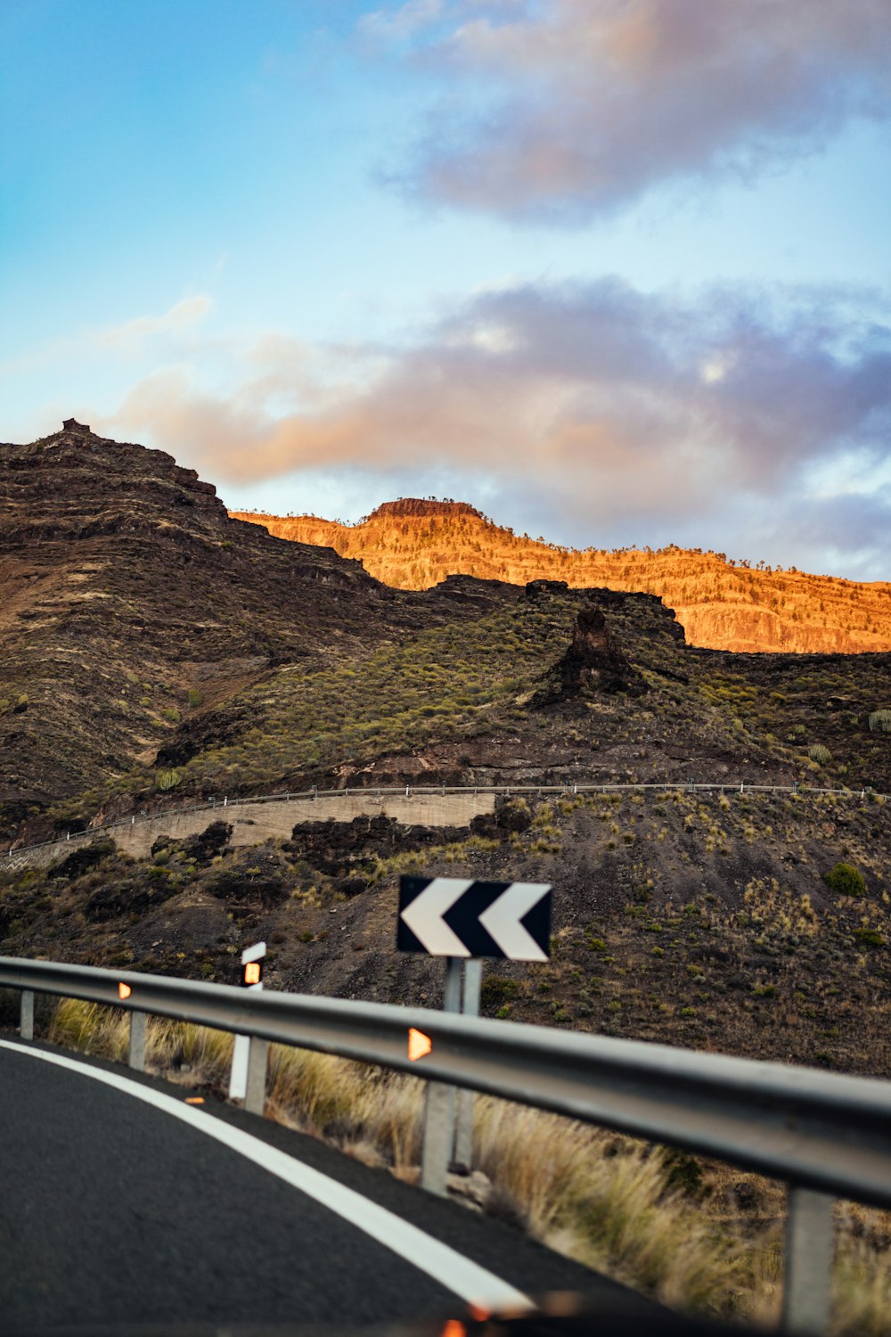 a view of a road with a mountain in the background