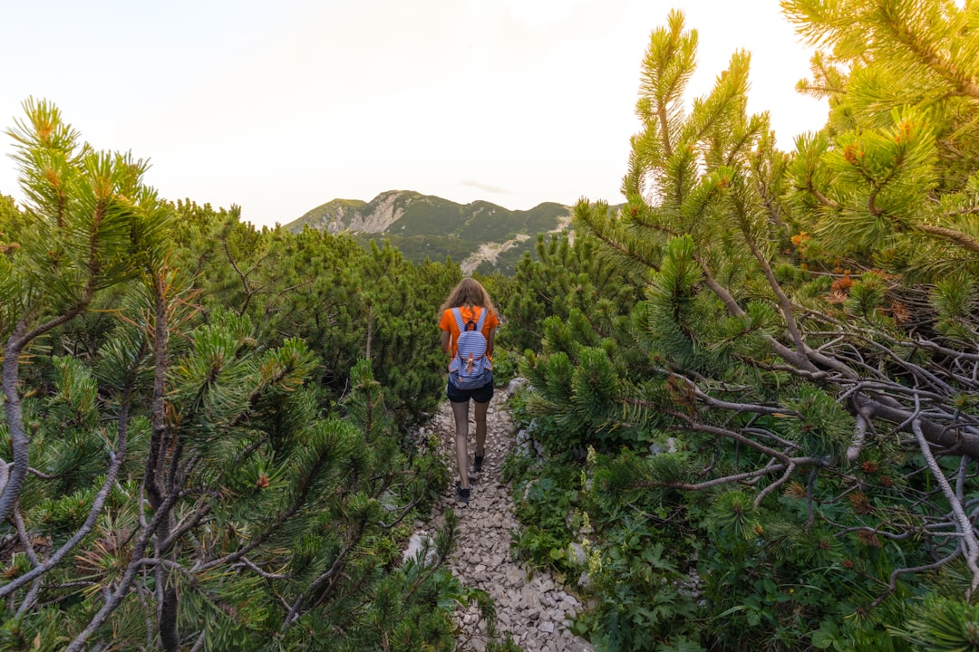 woman in red shirt walking in forest