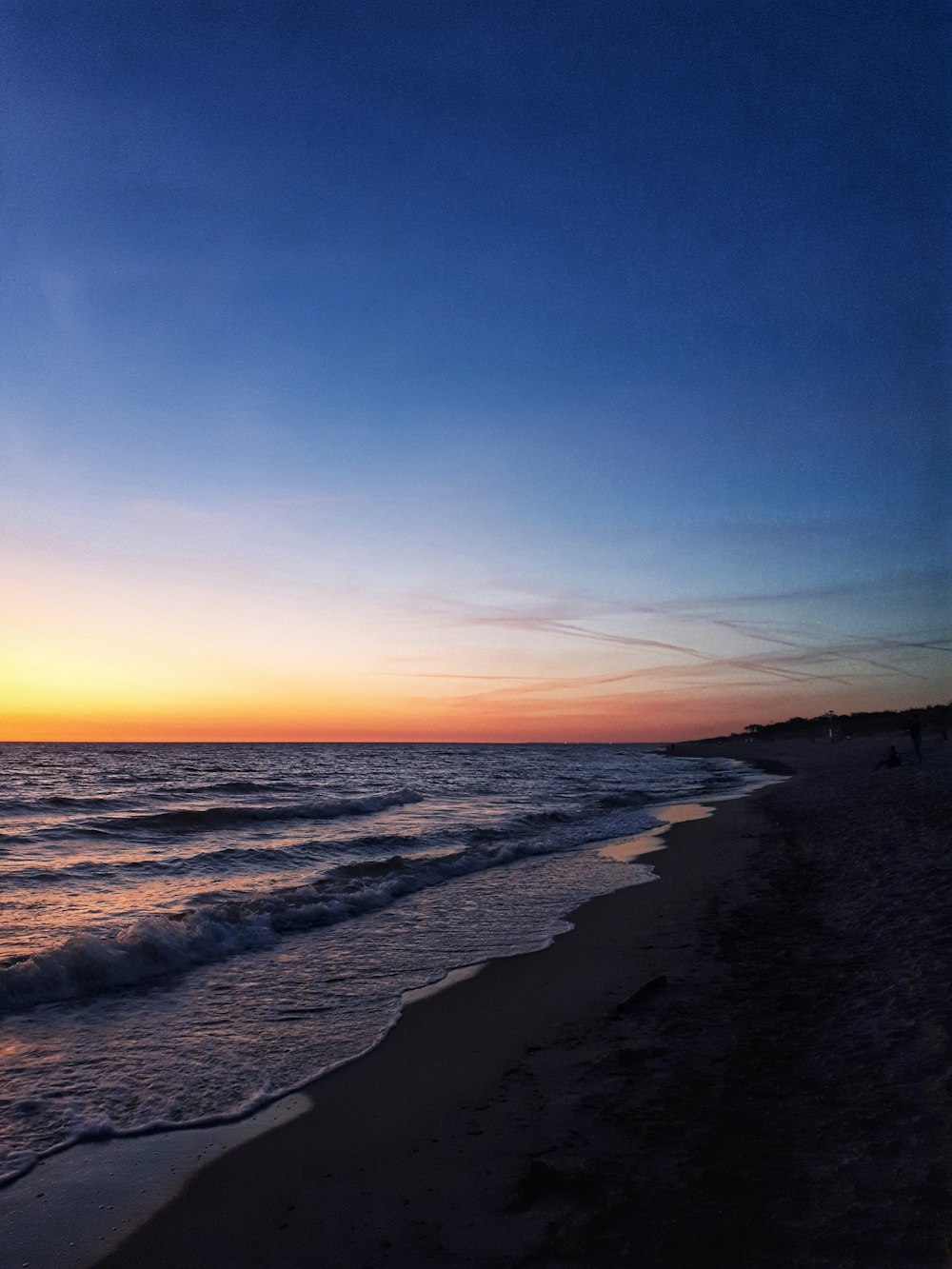 waves splashing on seashore during golden hour