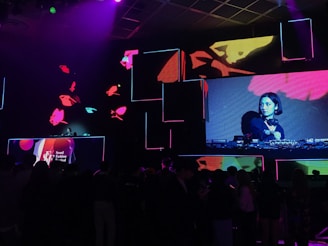 a group of people watching a video on a large screen