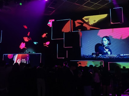 a group of people watching a video on a large screen